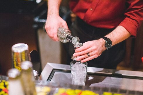 A picture of a bartender pouring tequila
